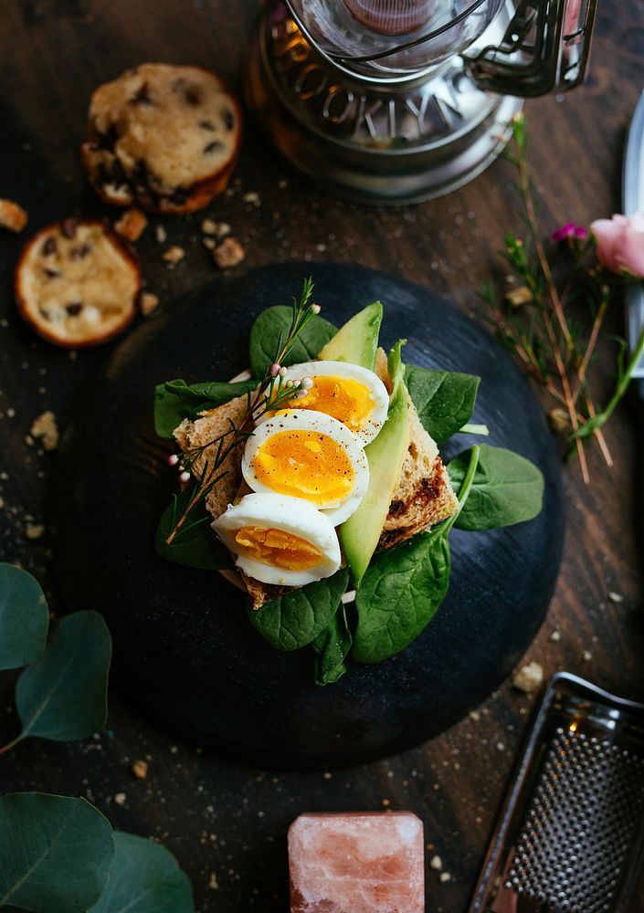 Avocado toast with egg and herbs on a rustic table. Original public domain image from Wikimedia Commons