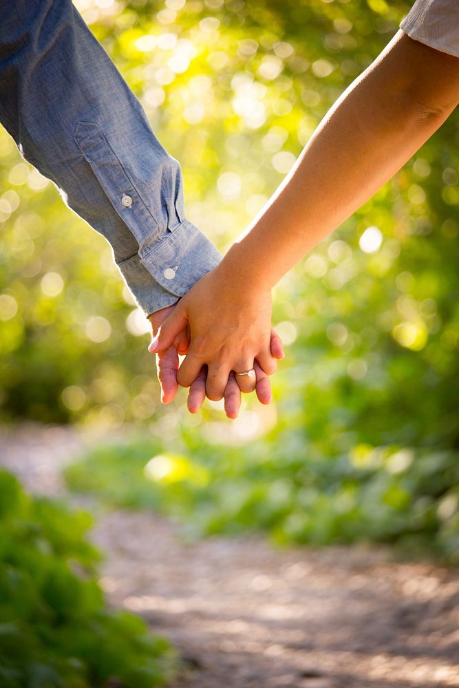 Close-up of couple's interlaced hands on a trail in afternoon. Original public domain image from Wikimedia Commons