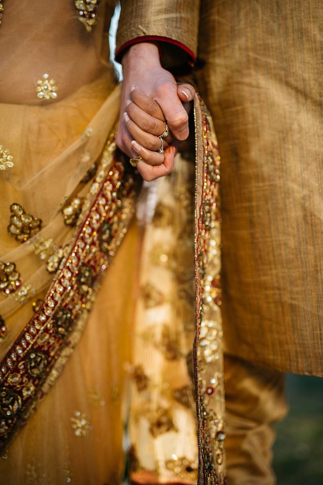 Couple in traditional garb holds hands at wedding. Original public domain image from Wikimedia Commons
