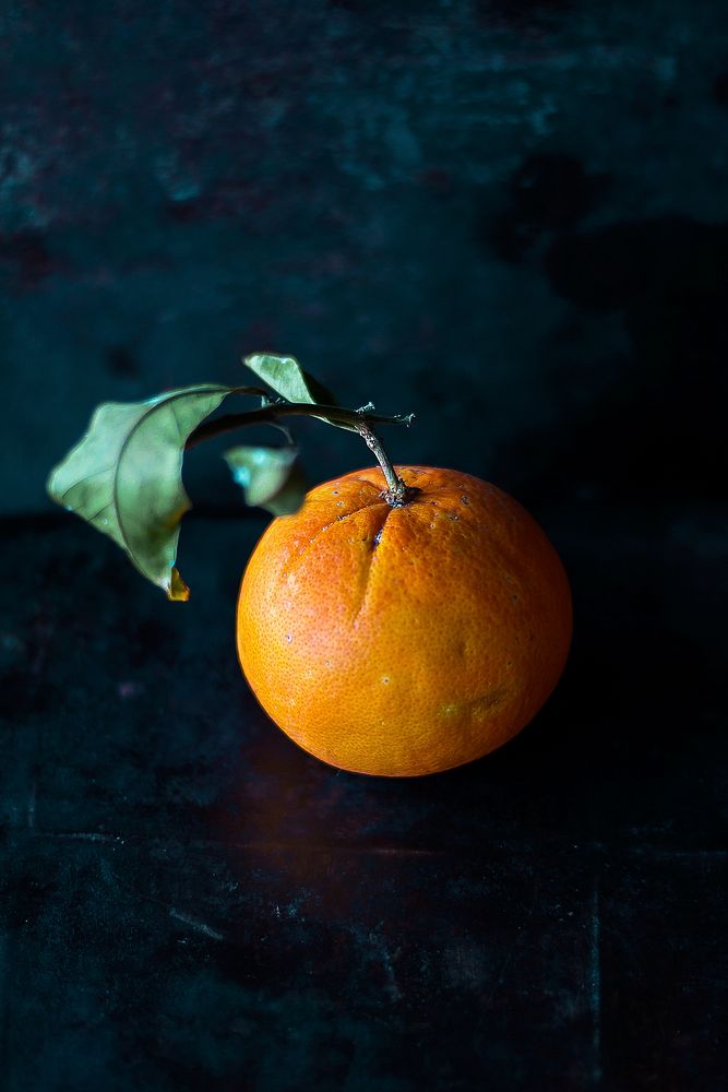 Orange on a black table. Original public domain image from Wikimedia Commons