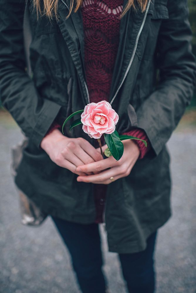 Woman holding a rose. Original public domain image from Wikimedia Commons