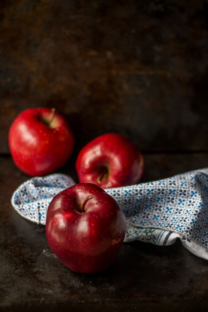 Three red apples on a kitchen linen napkin. Original public domain image from Wikimedia Commons
