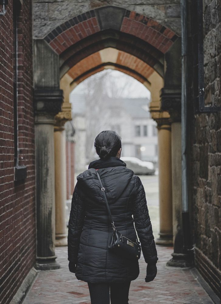 Woman walking through the arched alley. Original public domain image from Wikimedia Commons