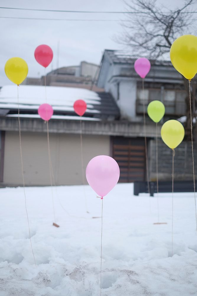 Colorful balloons are placed standing on the snow in Tokamachi.. Original public domain image from Wikimedia Commons