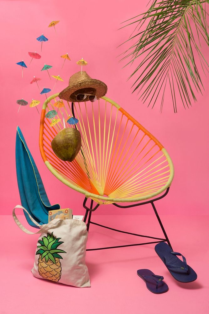 Colorful tropical scene with sunglasses, straw hat, chair and sandals and pink background wall, Guadalajara. Original public…