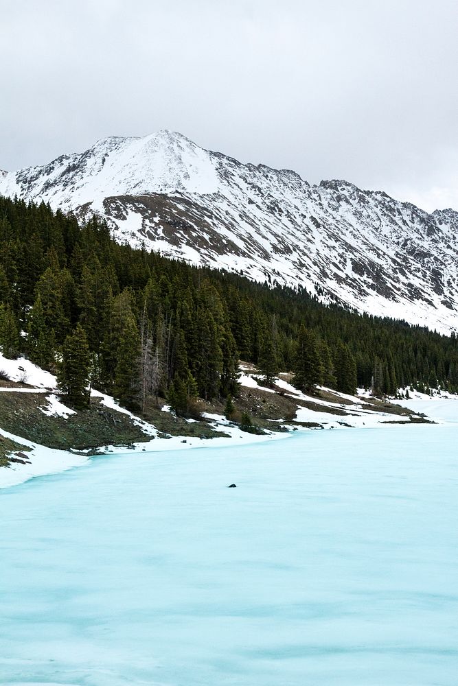 An icy blue half-frozen lake in the mountains in Summit County. Original public domain image from Wikimedia Commons