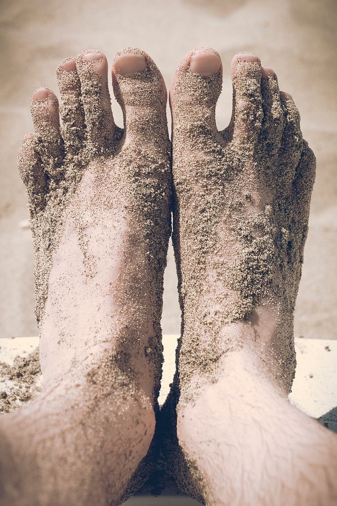 View of the feet covered in beach sand. Original public domain image from Wikimedia Commons