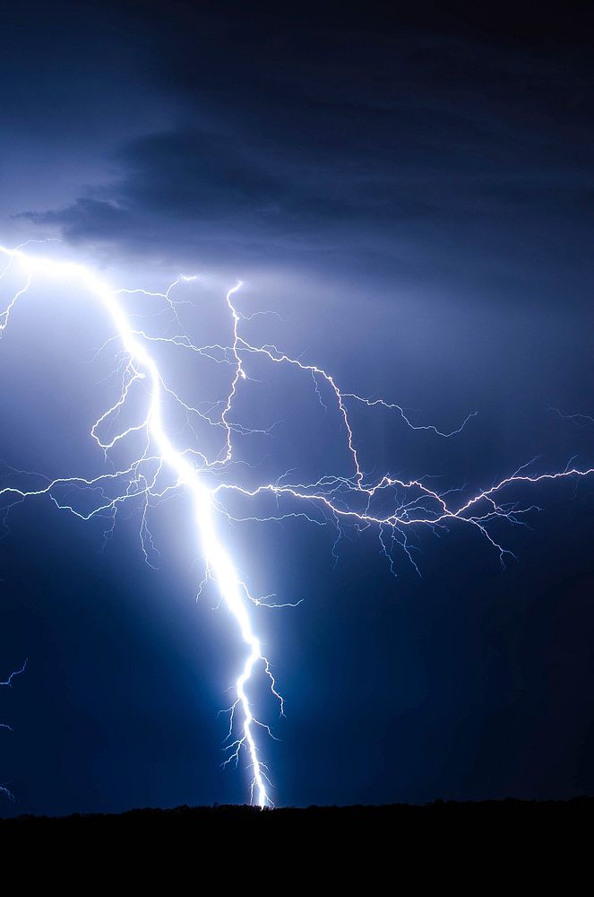 A lightning bolt in a storm. Original public domain image from Wikimedia Commons