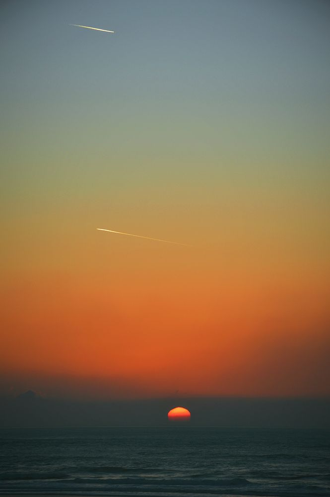 Shooting stars, sunset, sea, beach. Original public domain image from Wikimedia Commons