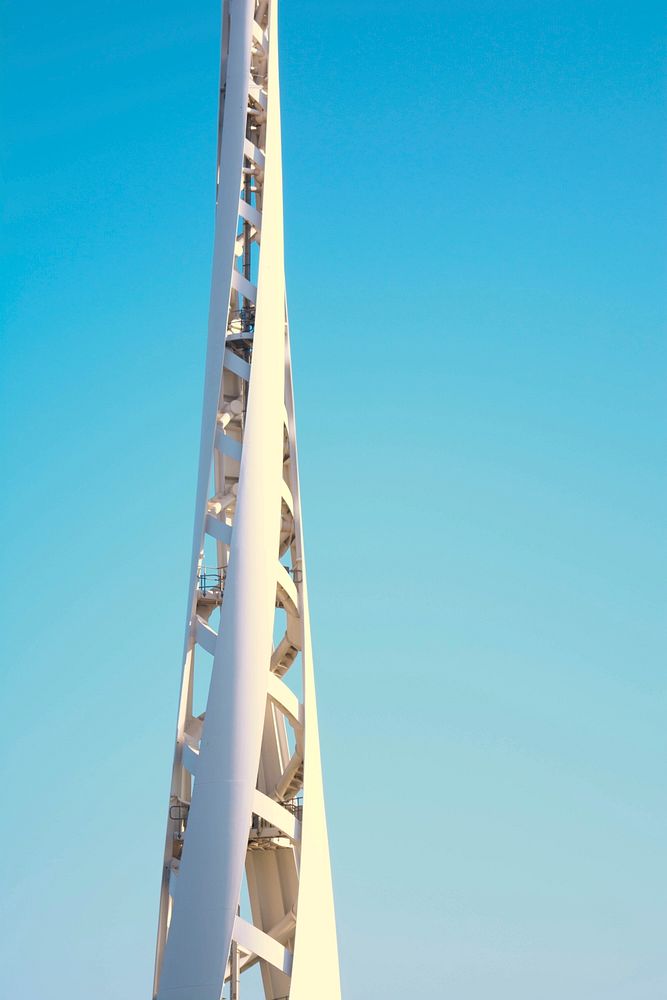 A tall twisting white structure against a blue sky. Original public domain image from Wikimedia Commons