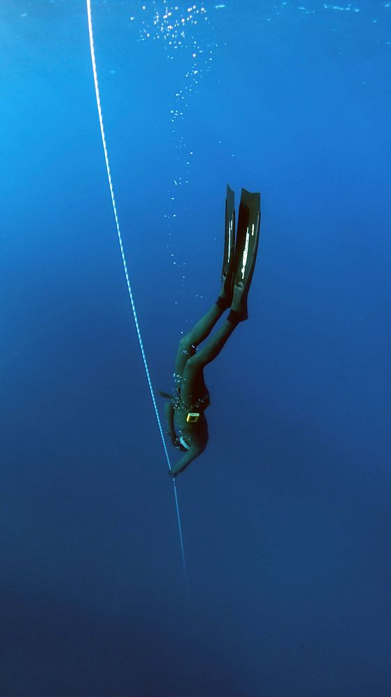 Person diving into the deep sea. Original public domain image from Wikimedia Commons