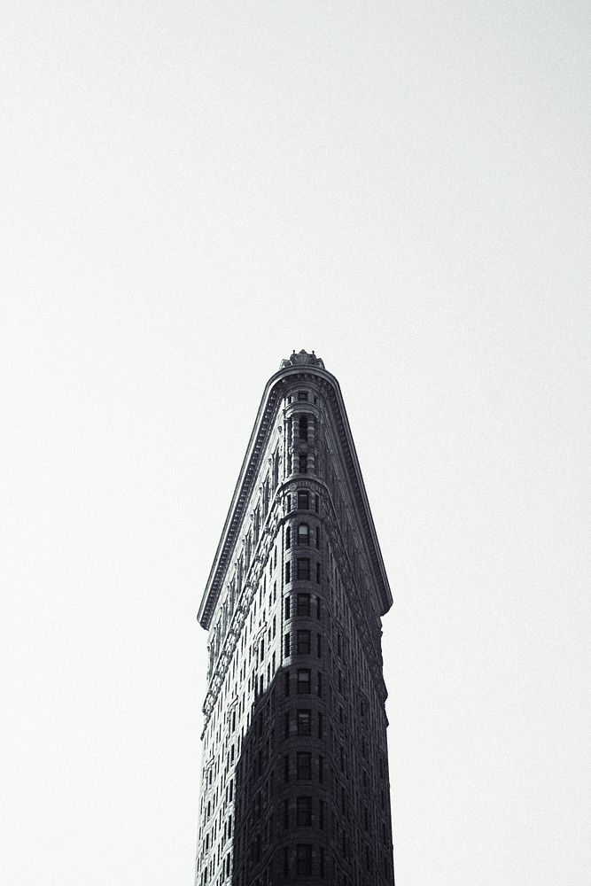 Black and white long shot of Flatiron building in New York with clear sky. Original public domain image from Wikimedia…