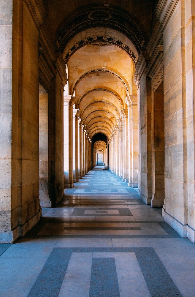 Hallway with pillars, curved ceilings, and patterns on the floor. Original public domain image from Wikimedia Commons
