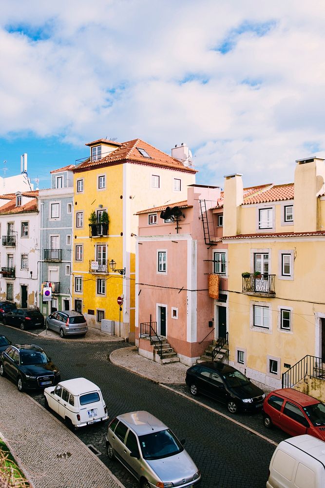 Street with small residential buildings with colorful facades in Lisbon. Original public domain image from Wikimedia Commons
