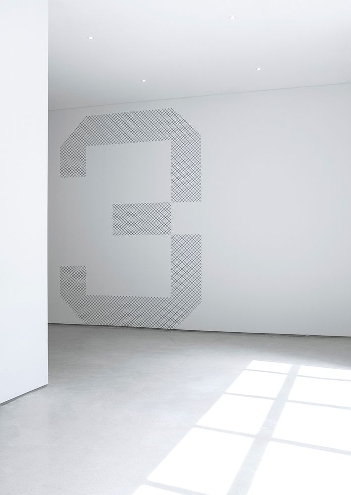 A large number three painted on a white wall in an empty room. Original public domain image from Wikimedia Commons