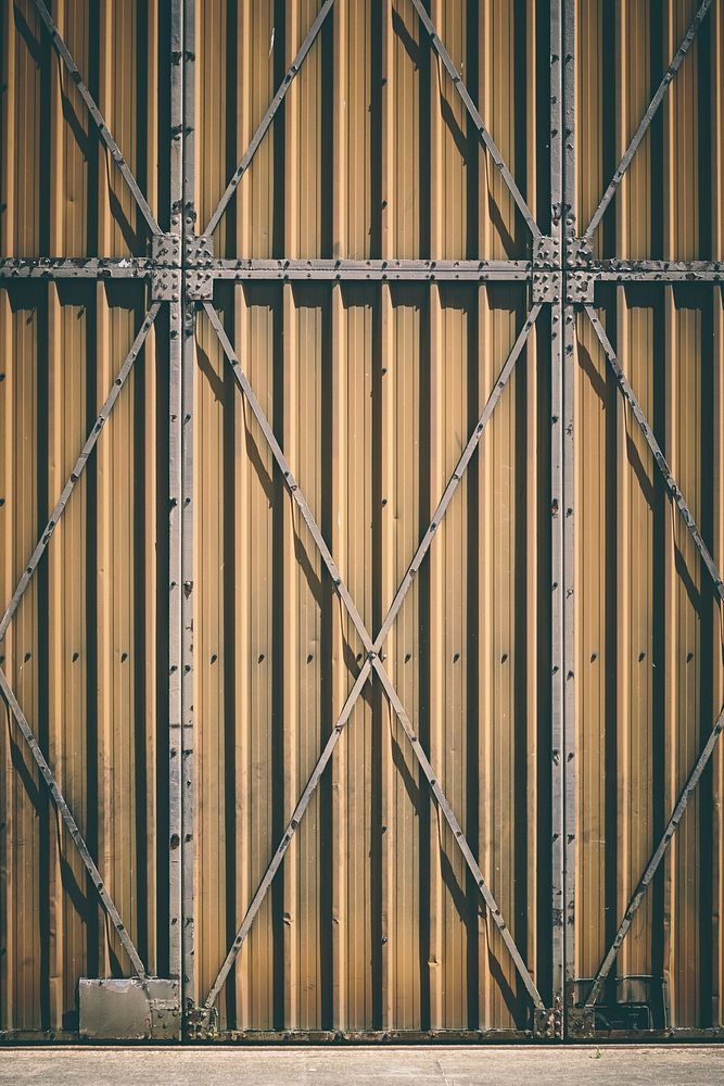 Heavy industrial door with steel support bars. Original public domain image from Wikimedia Commons