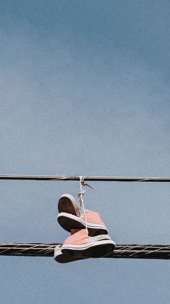 Pink sneakers hanging on an electricity line in downtown LA mobile wallpaper