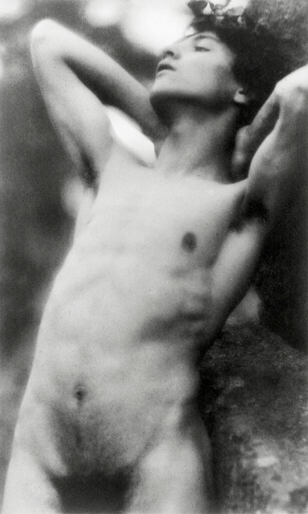 Nude photography of naked man: Portrait Photograph of nude youth with laurel wreath against rock with hands behind neck…