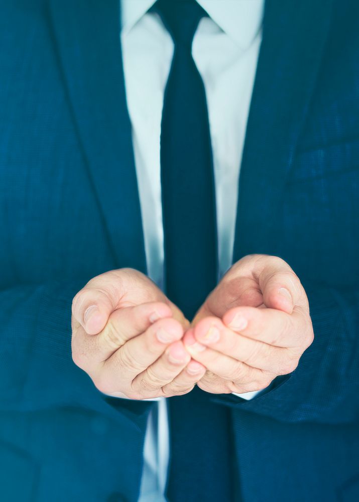 Businessman in suit putting hands together