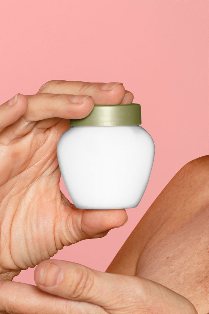 Blank face cream jar in woman's hand