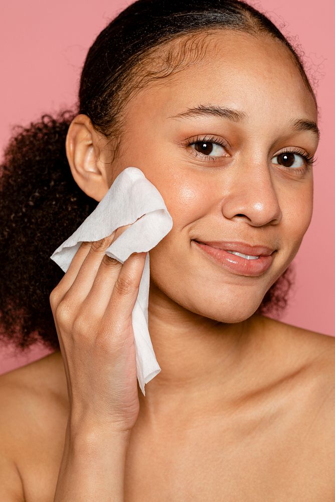 Woman using makeup remover wet tissue 
