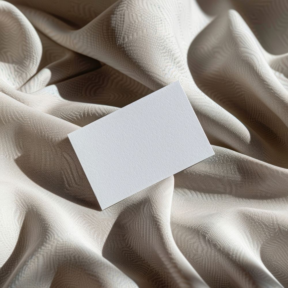 Blank white business card paper text.