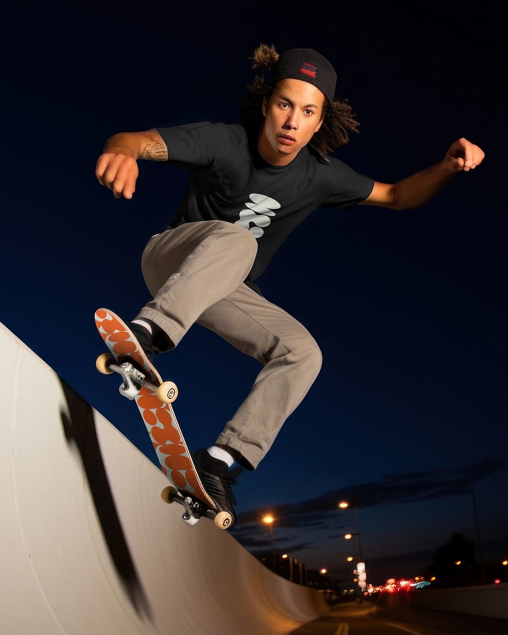 Man playing skateboard at night
