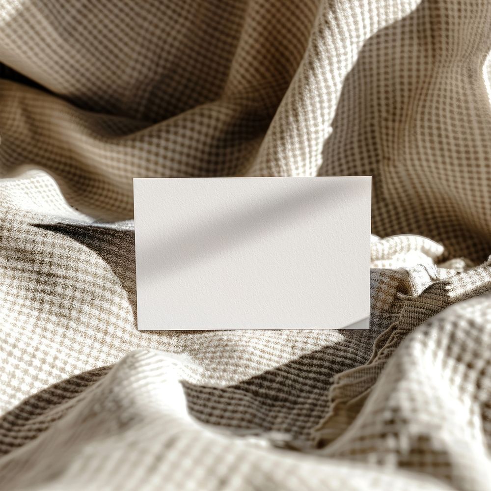 Blank white business card mockup blanket person linen.
