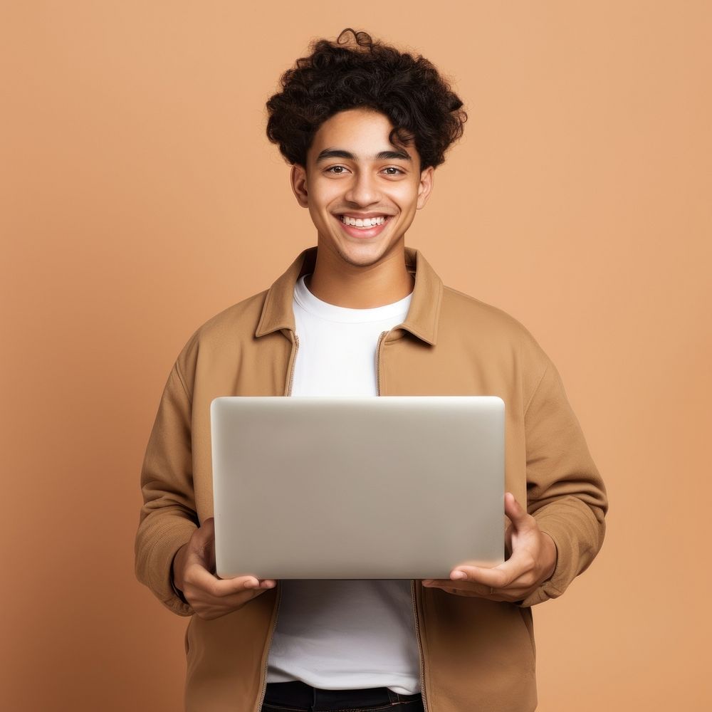 Smiling man holding laptop