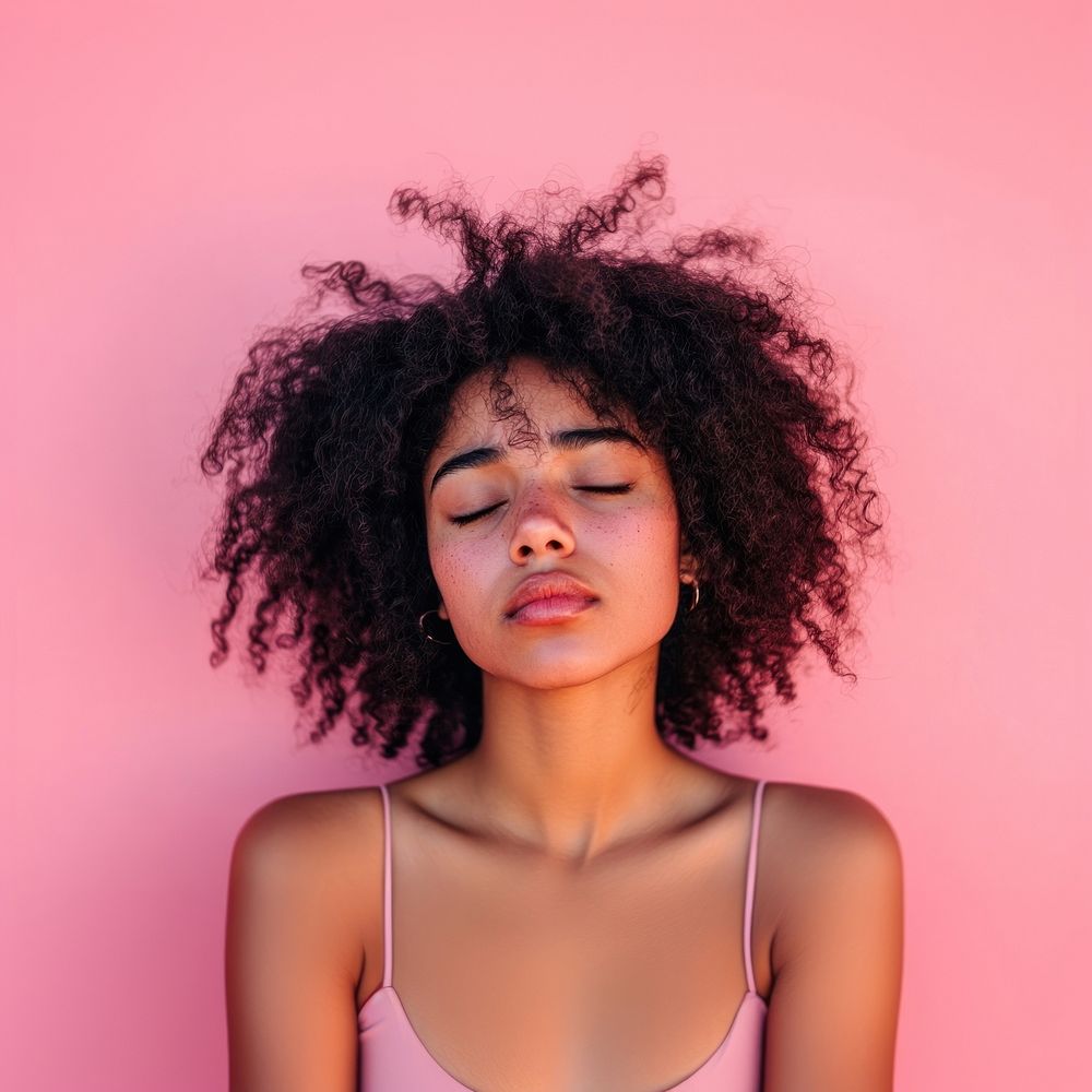 Serene woman against pink background