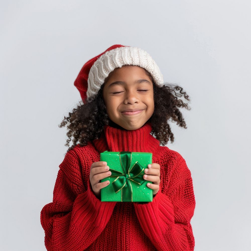 A cute African American girl wearing a red Christmas sweater christmas clothing present.