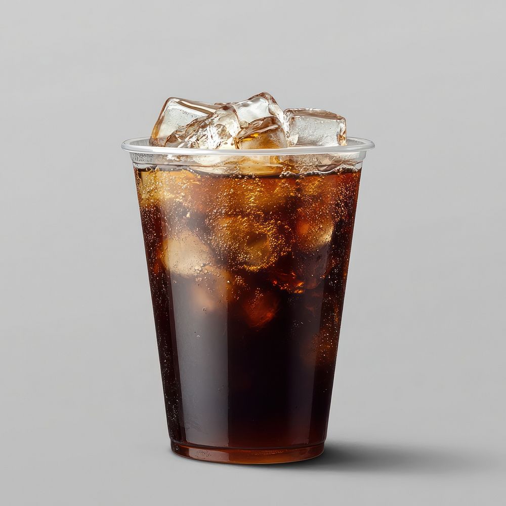 An isolated plastic cup of an ice americano coffee with coconut juice at the bottle drink beverage soda.