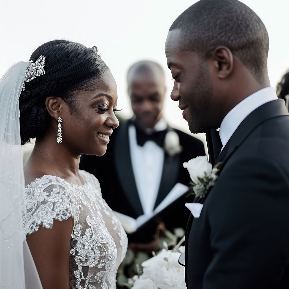 Black couple exchanging their vows wedding tuxedo dress.