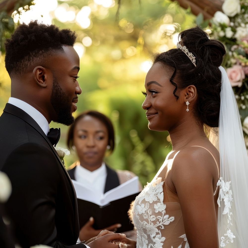 Black couple exchanging their vows wedding tuxedo dress.