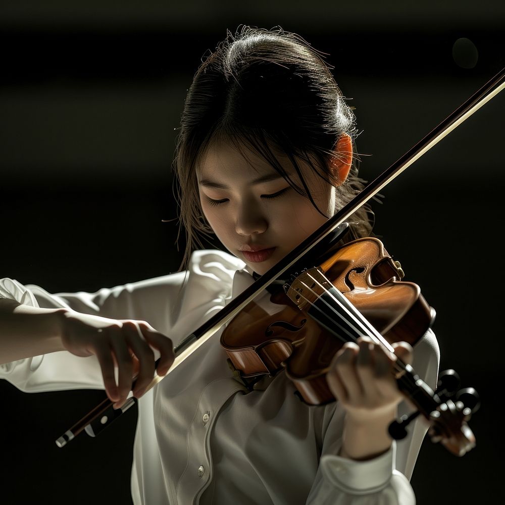 Chinese high school woman violin musician concentration.