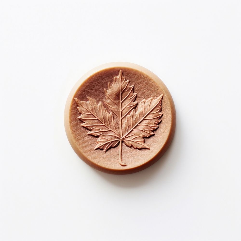 Wax Stamp maple leaf imprint white background currency pottery.