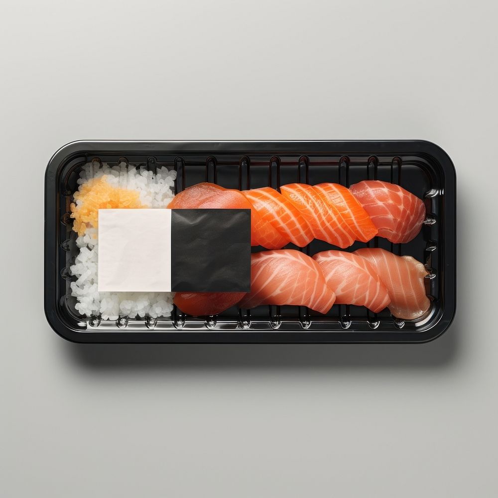 Sealable black plastic tray and cover with sushi and blank label  packaging seafood meat rice.