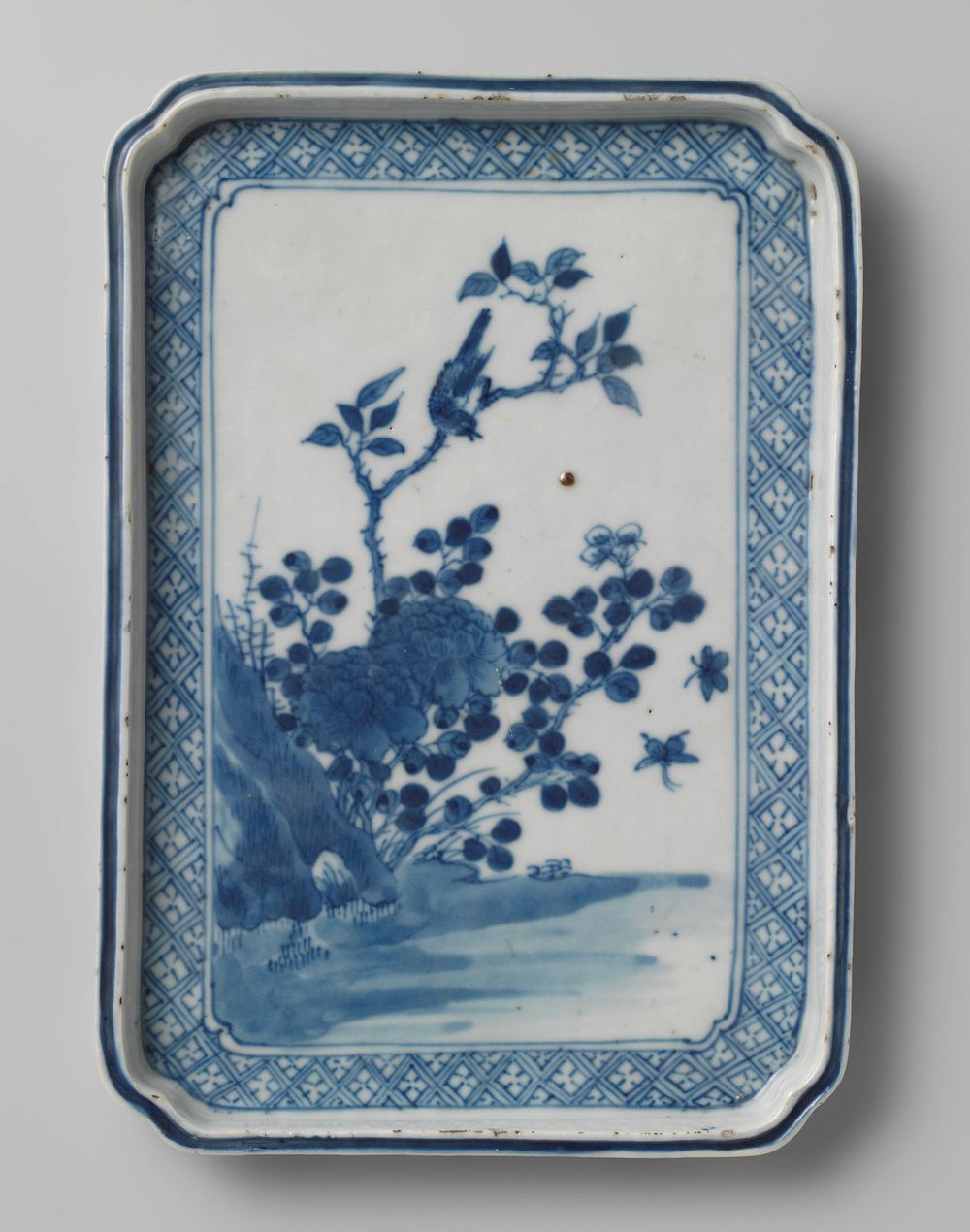 Rectangular dish with flowering plants, a bird and insects near a rock (c. 1700 - c. 1799) by anonymous