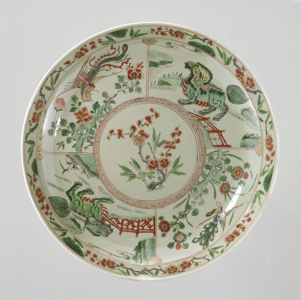 Saucer-dish with celadon glaze, prunus sprays, shishi, peacock and feng huangs (c. 1700 - c. 1724) by anonymous