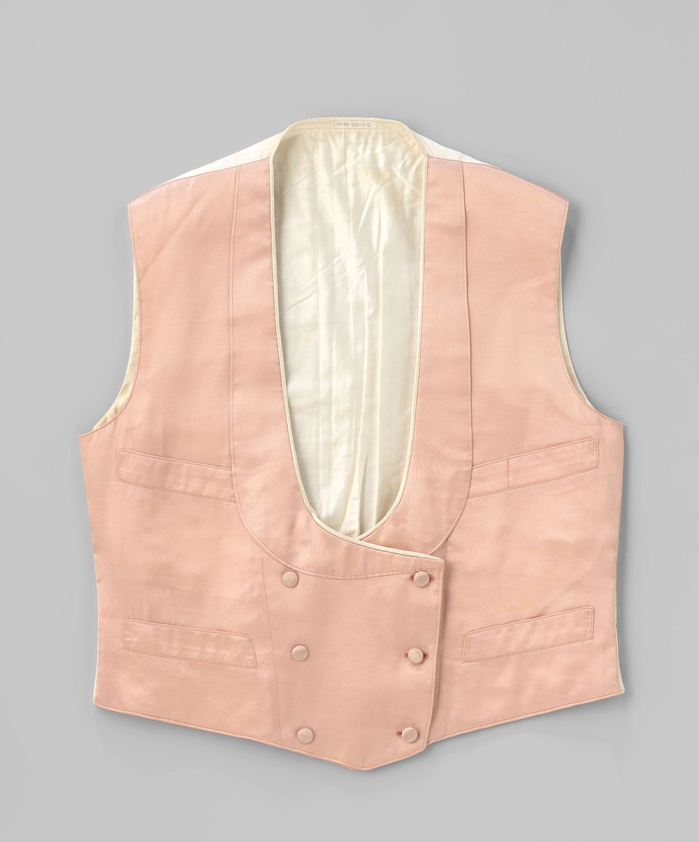 Vest met een achterkant van wit katoen en een voorkant met 4 steekzakken, overslag naar links met tweemaal drie stofknopen…