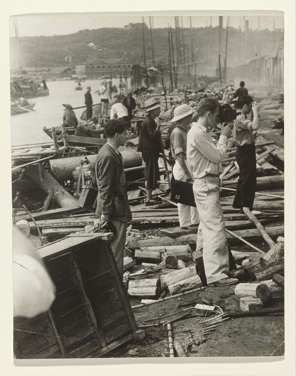 Joris Ivens, John Fernhout and Robert Capa at Work in the Bombed City of Hankow (1938) by anonymous