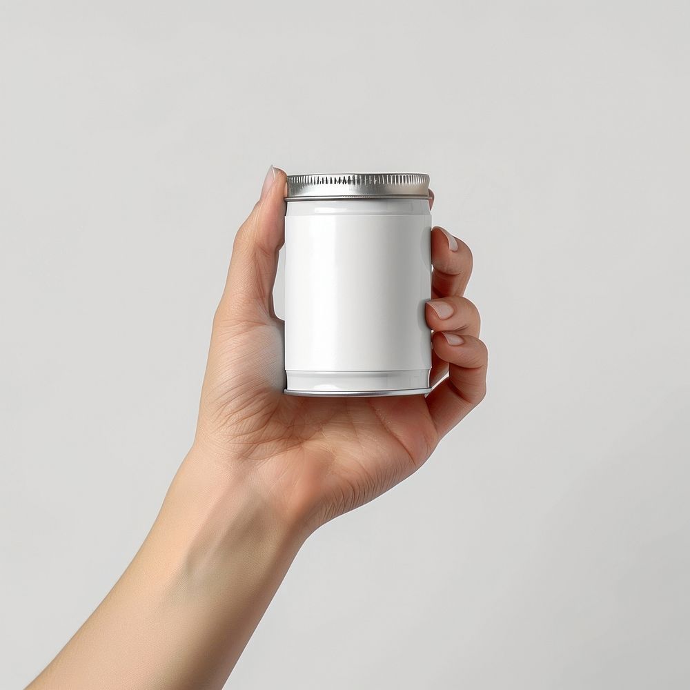 Hand holding food short can with blank label  packaging refreshment container drinkware.