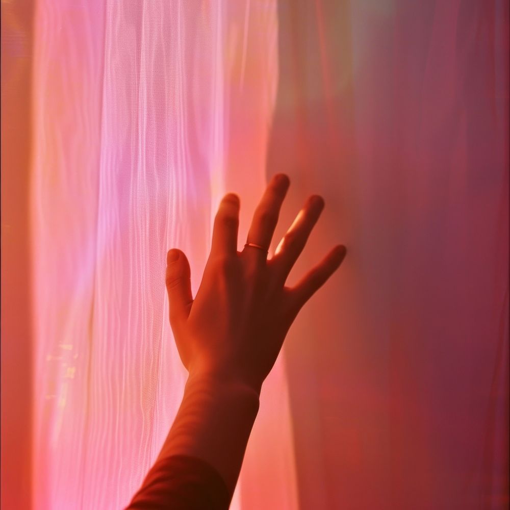 Blurred hand finger pink darkness.