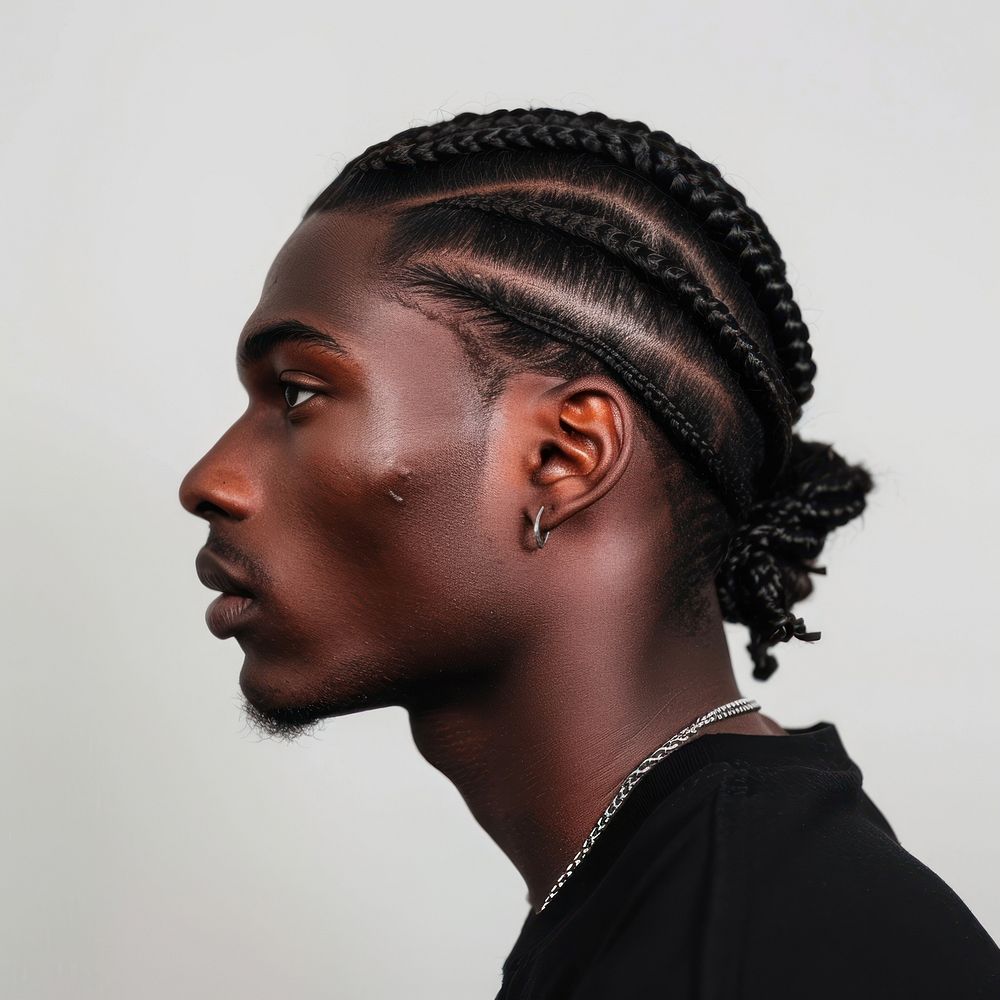 Handsome black young man portrait cornrows head.