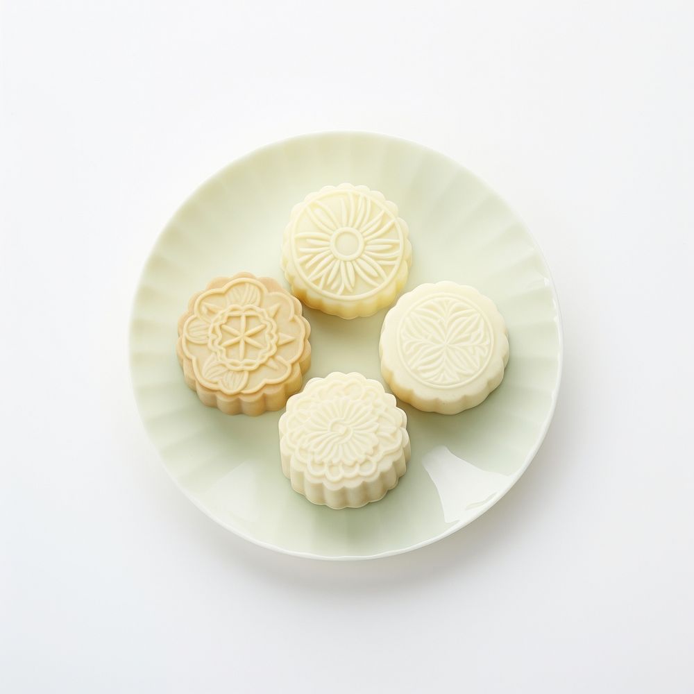 A mooncake show inside is pineaplee flavor put on plate dessert icing food.