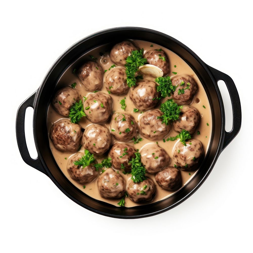 Swedish meatballs in a retro black dutch oven pot food meal white background.