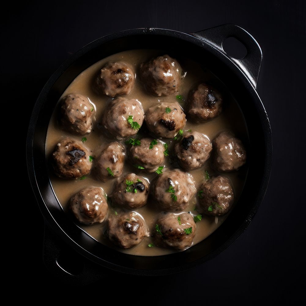 Swedish meatballs in a retro black dutch oven pot food vegetable freshness.