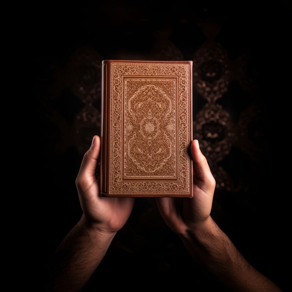 Hand Holding al quran hand holding publication. AI generated Image by rawpixel.