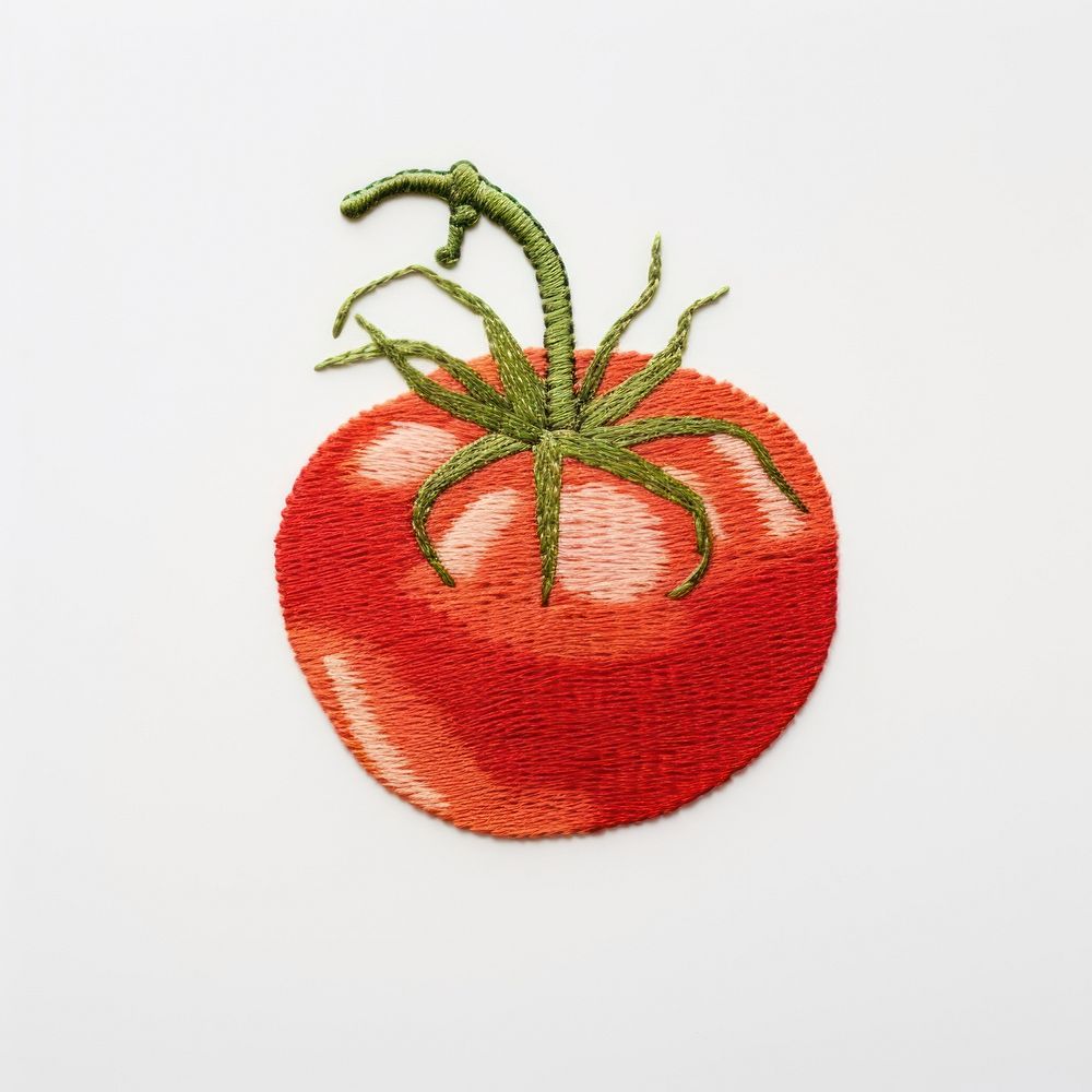 A tomato in embroidery style needlework vegetable textile.