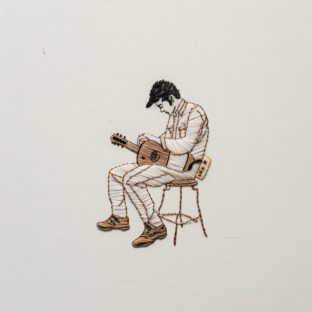 A man playing laptop in embroidery style drawing guitar sketch.